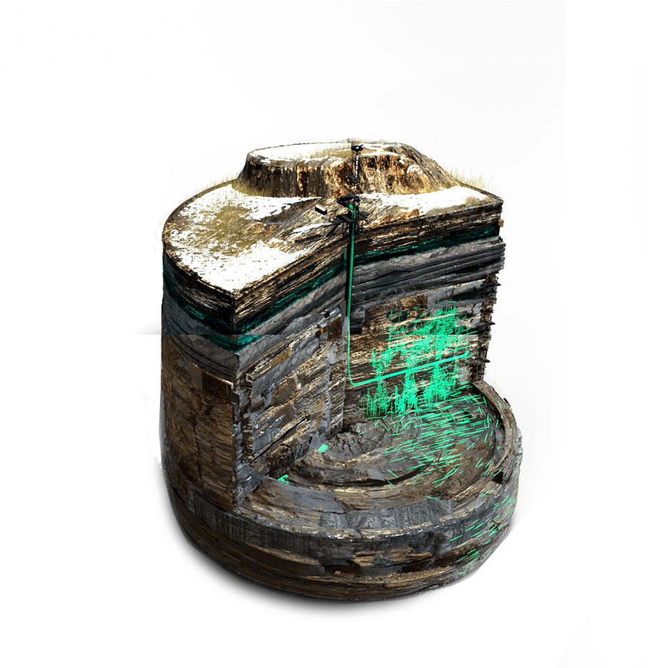 A green light is on the top of a building.